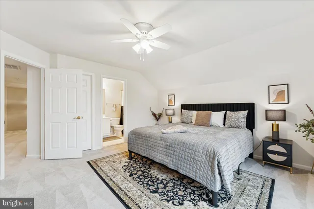 a bathroom with a sink a toilet a mirror and shower curtain