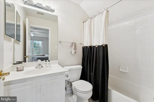 a bedroom with a large bed and a large window