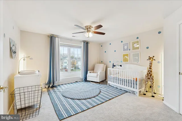 a view of a livingroom with an empty space & a ceiling fan