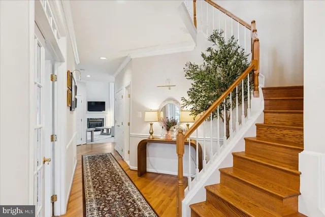 a view of entryway and hall with wooden floor
