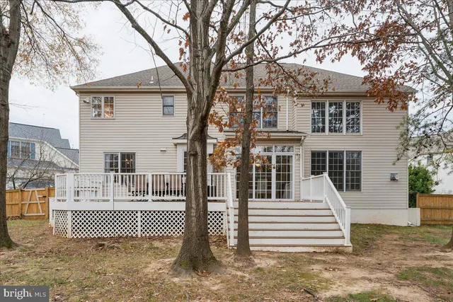 a aerial view of a house with barbeque oven and large trees