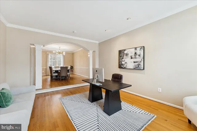 a living room with furniture a rug and a table