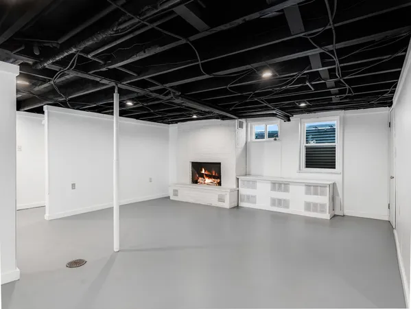 a view of an empty room with wooden shelves
