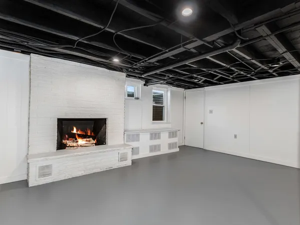 a view of an empty room with fire place and a fireplace