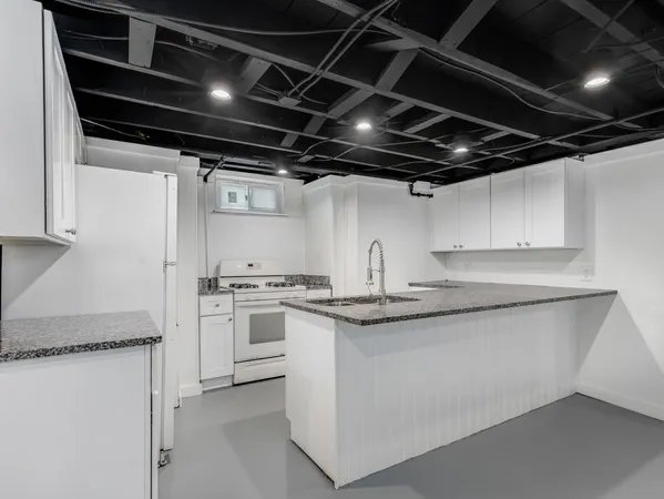 a kitchen with stainless steel appliances granite countertop a sink stove and refrigerator