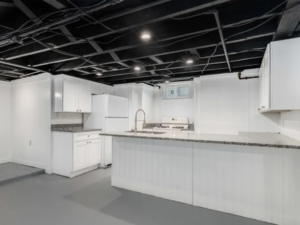 a kitchen with granite countertop a sink and cabinets
