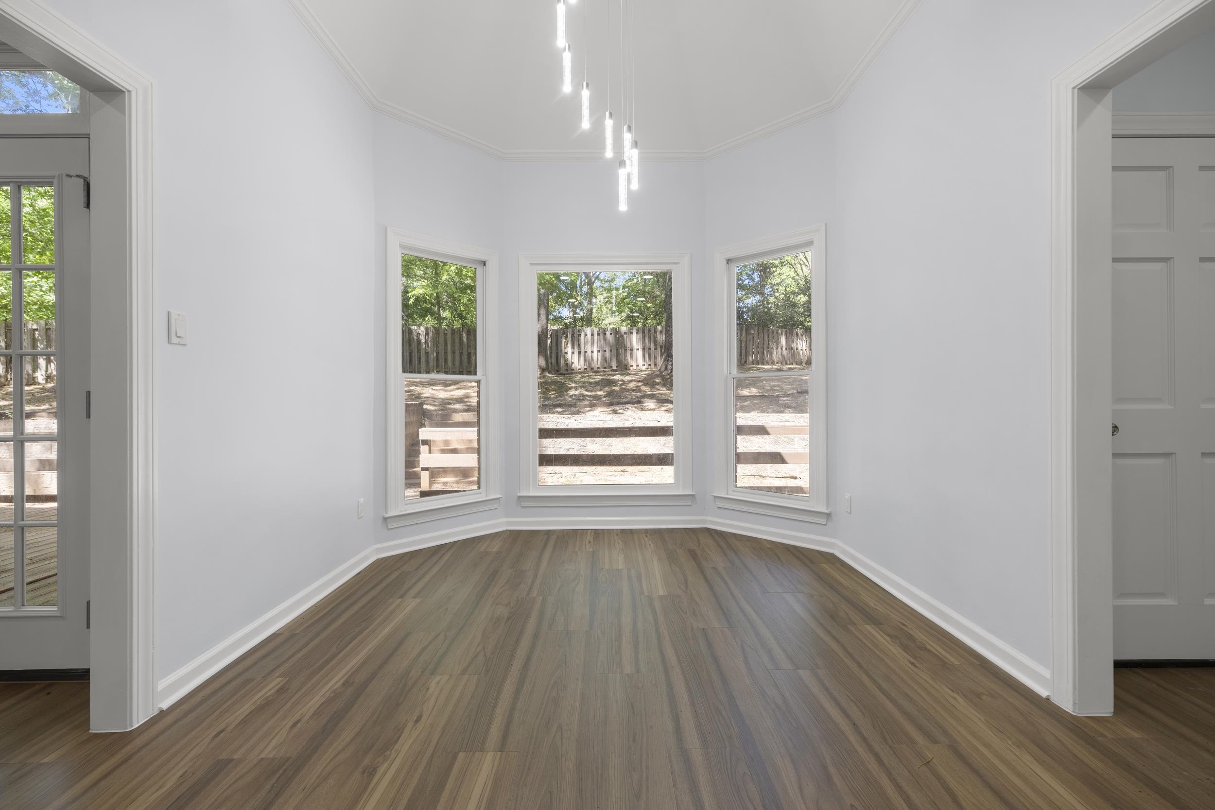 486 Brook Ridge Circle Memphis, TN 38018 - Photo 18 of 40 Unfurnished dining area with dark wood-type flooring, healthy amount of natural light, and ornamental molding
