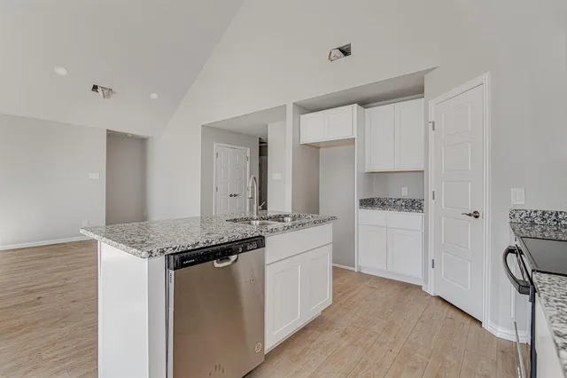 a kitchen with stainless steel appliances granite countertop a sink stove and microwave