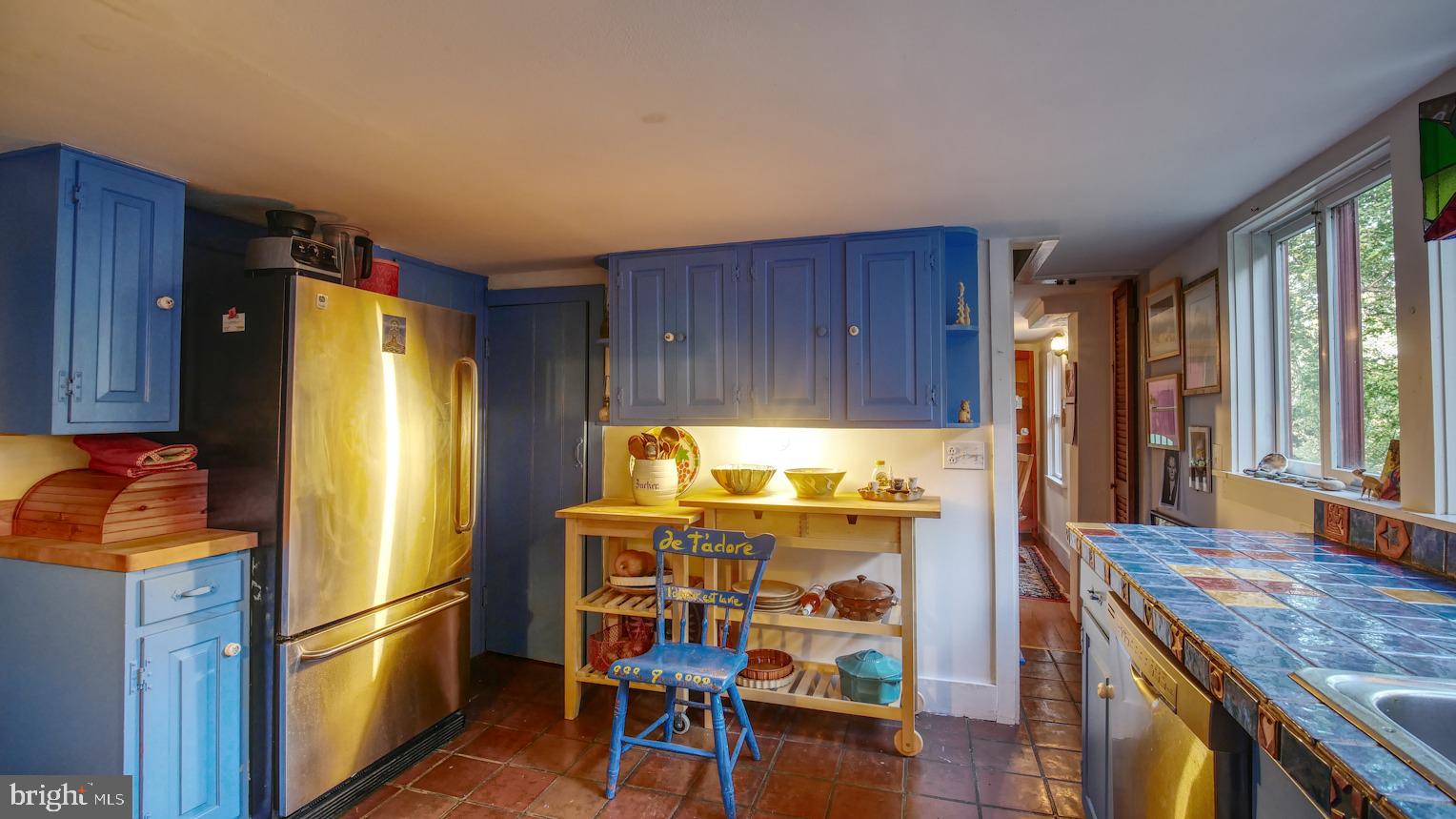 7416 Ferry Road New Hope, PA 18938 - Photo 13 of 33 a kitchen with stainless steel appliances granite countertop a refrigerator a stove and a dining table with wooden floor