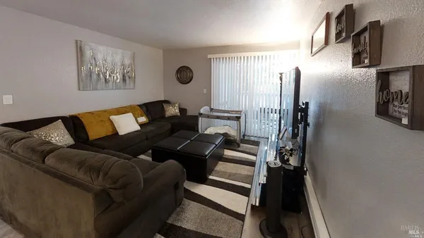 a living room with furniture and a rug