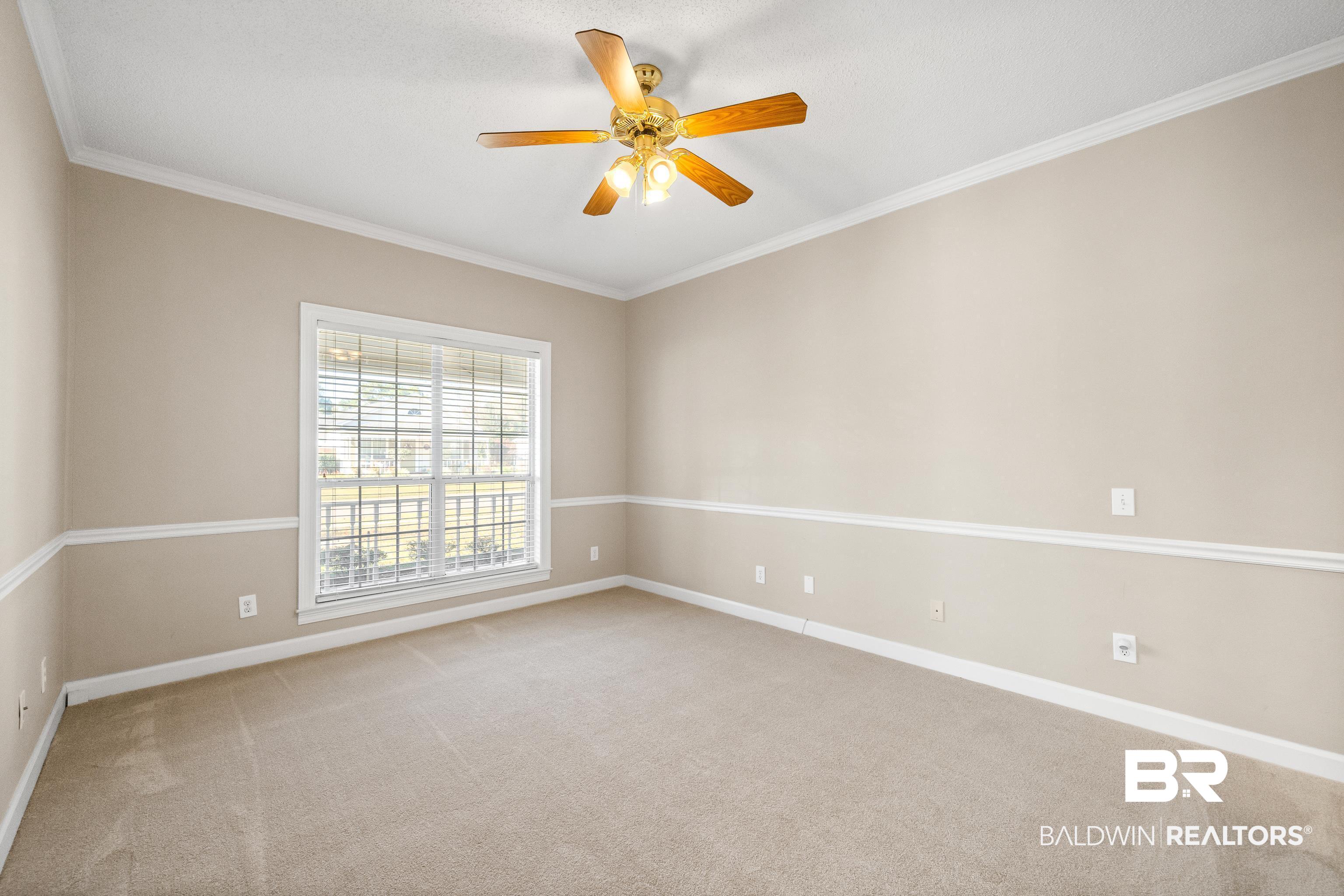 27 Cottage Drive Fairhope, AL 36532 - Photo 15 of 33 Spare room featuring ornamental molding, light carpet, and a ceiling fan