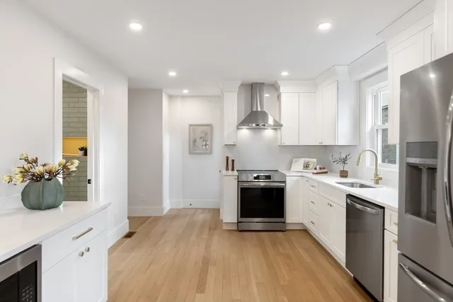 a kitchen with stainless steel appliances granite countertop a sink stove and refrigerator