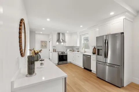a kitchen with a refrigerator sink and stove top oven