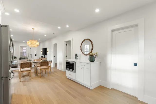 a view of a kitchen with dining table and chairs