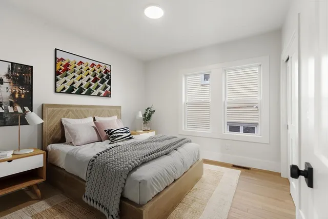 a bedroom with bed and a window