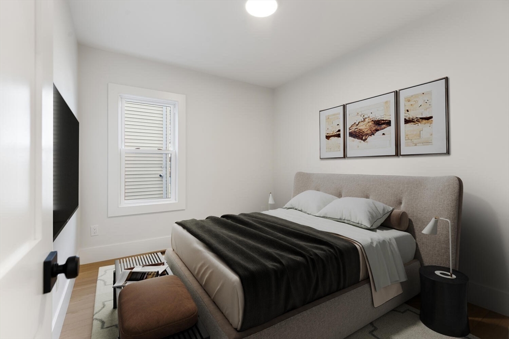 7 Bennett Street, Unit 1 Medford, MA 02155 - Photo 15 of 38 a bedroom with a bed and a window