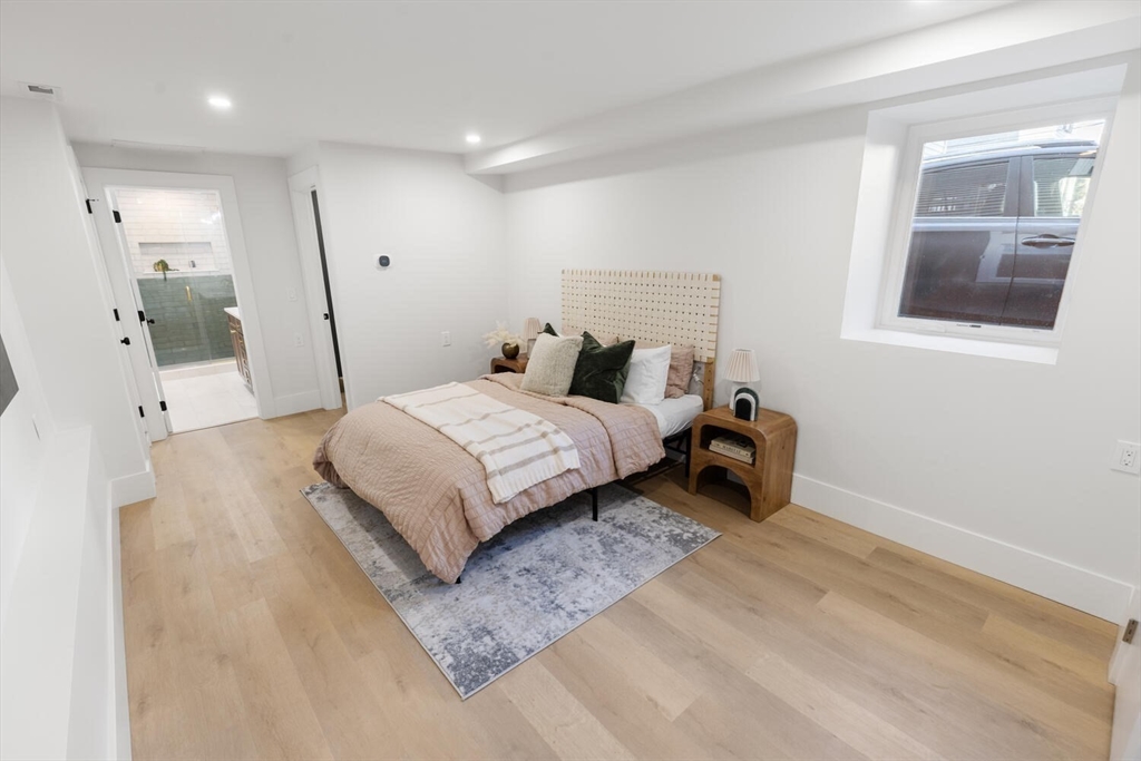 7 Bennett Street, Unit 1 Medford, MA 02155 - Photo 21 of 38 a bedroom with a bed and a window