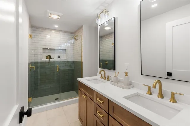 a bathroom with a sink double vanity and shower