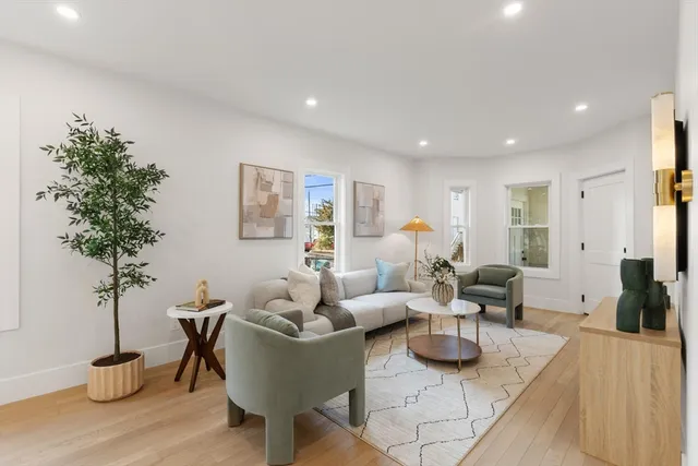 a living room with furniture potted plant and a table