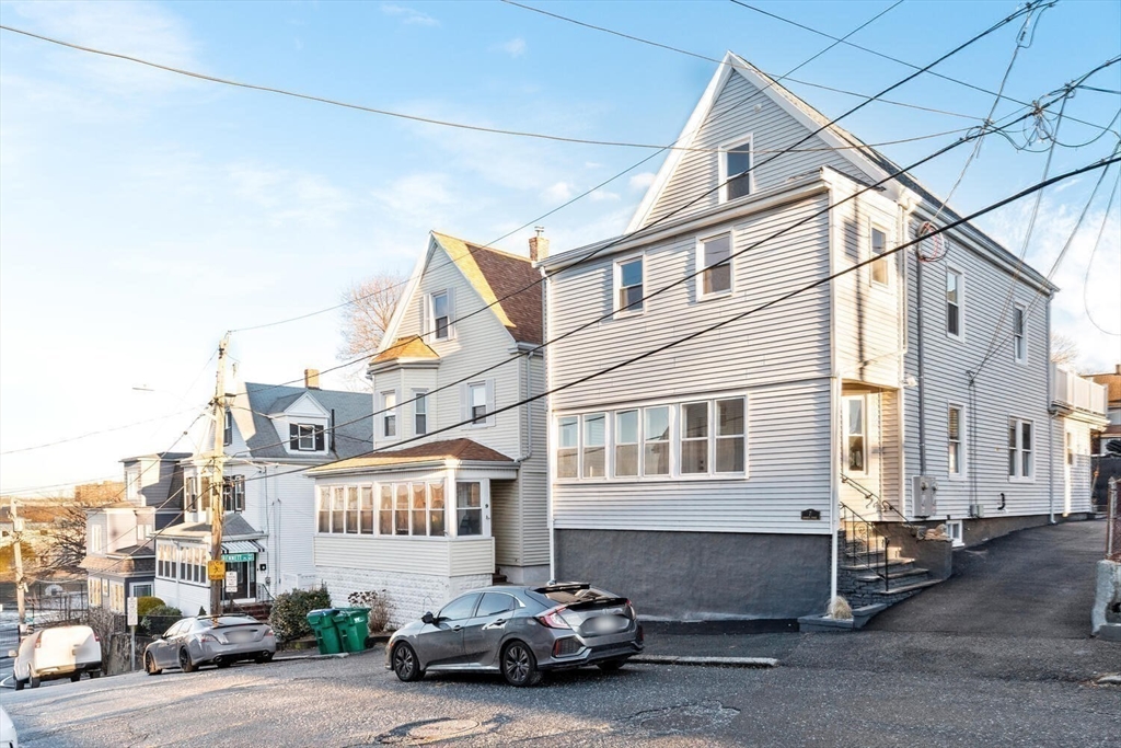 7 Bennett Street, Unit 1 Medford, MA 02155 - Photo 36 of 38 a car parked in front of a building