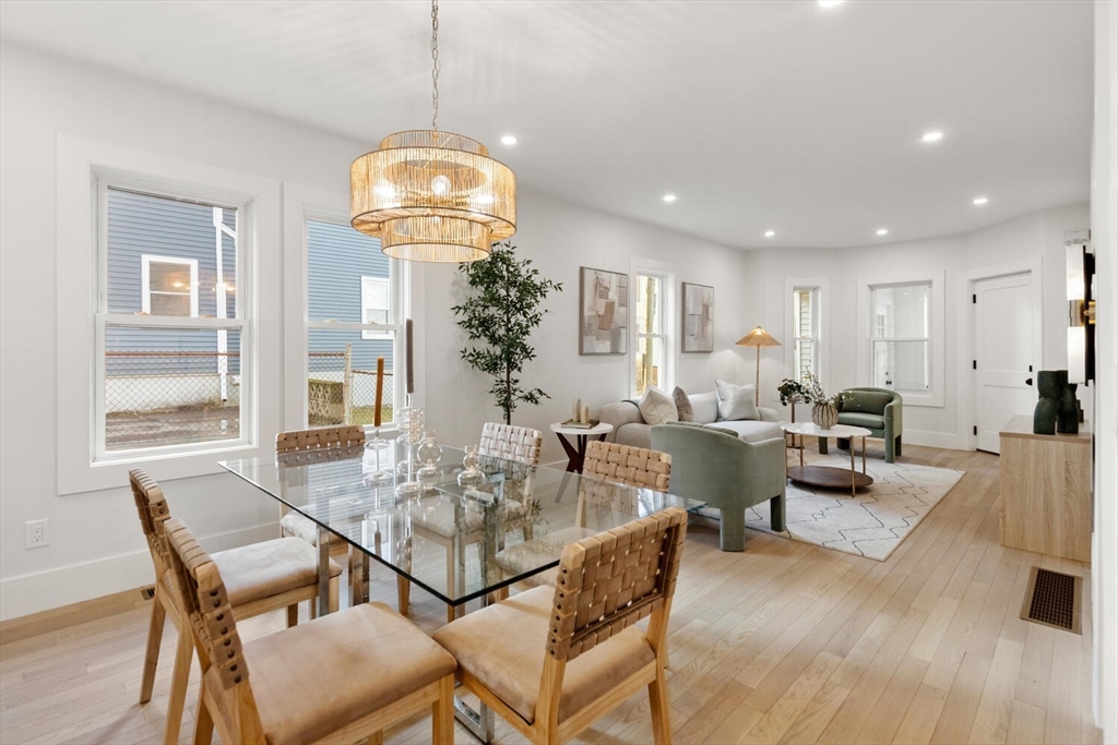 7 Bennett Street, Unit 1 Medford, MA 02155 - Photo 6 of 38 a view of a dining room with furniture and wooden floor