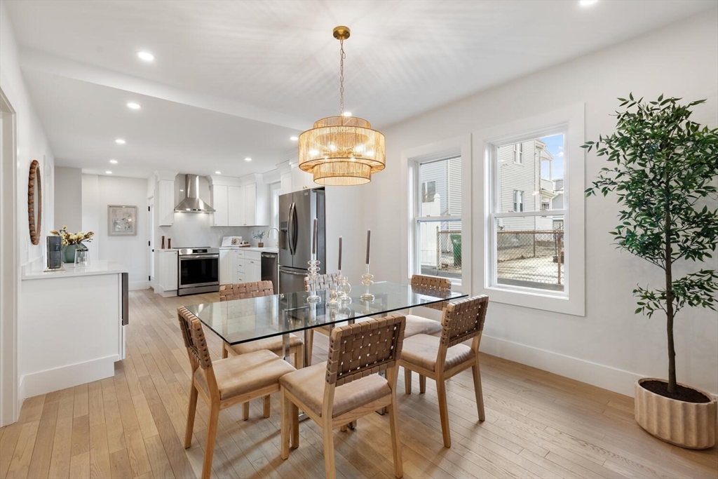 7 Bennett Street, Unit 1 Medford, MA 02155 - Photo 7 of 38 a view of a dining room with furniture window and wooden floor