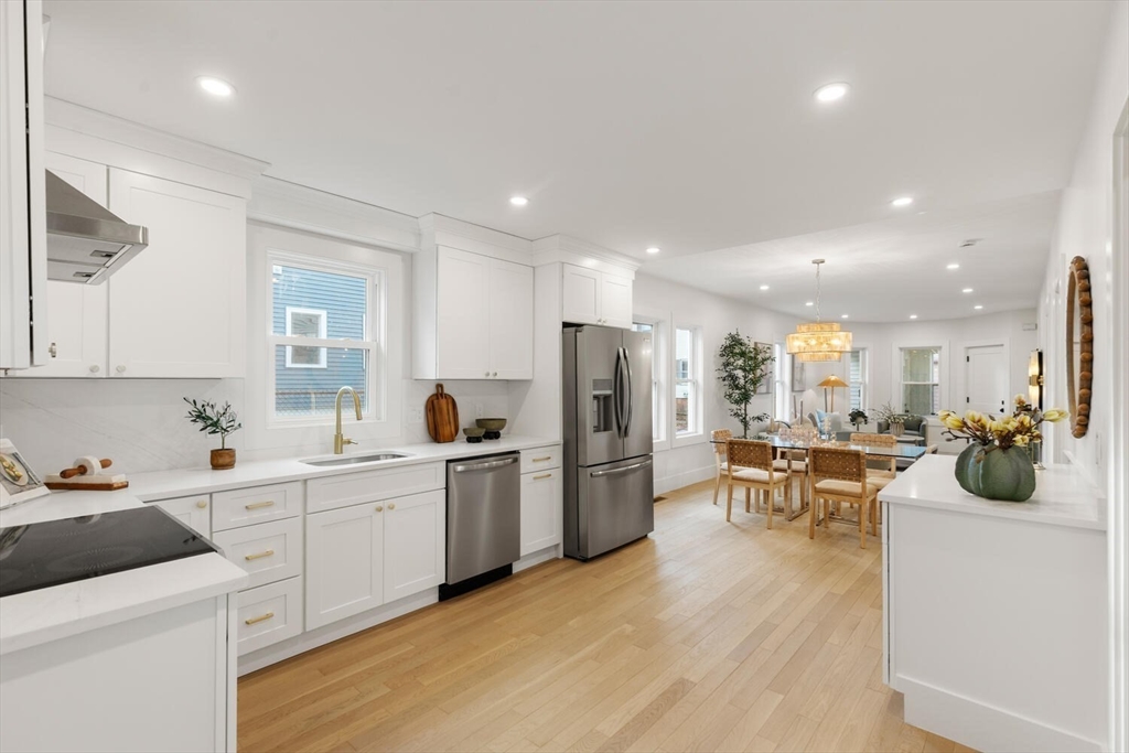 7 Bennett Street, Unit 1 Medford, MA 02155 - Photo 8 of 38 a kitchen that has a lot of cabinets a sink and appliances in it