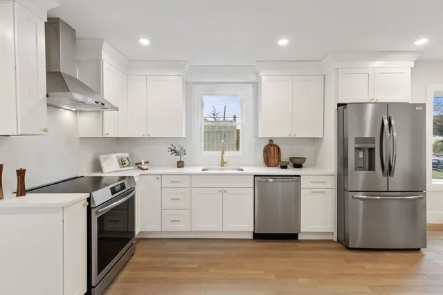 a kitchen with a white stove top oven and refrigerator