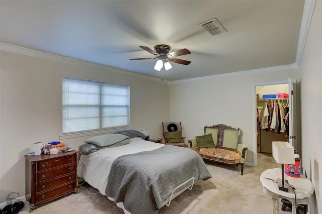 a bedroom with bed and a chandelier