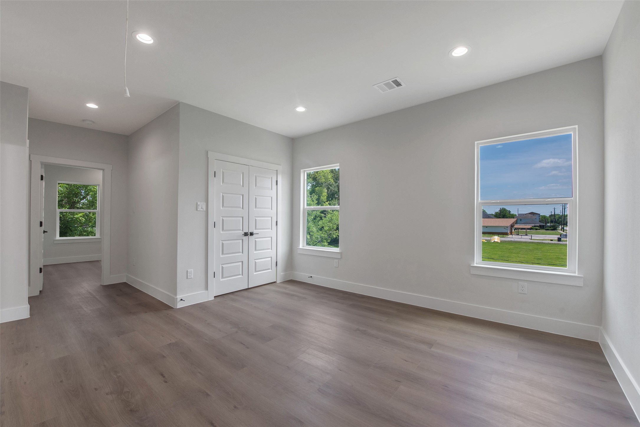 9311 Jutland Road Houston, TX 77033 - Photo 14 of 28 A spacious upstairs flex space, filled with natural light from the windows, offers versatile use for work, play, or relaxation, with bedrooms located just off the space for added convenience and privacy, along with a utility closet for practical storage.