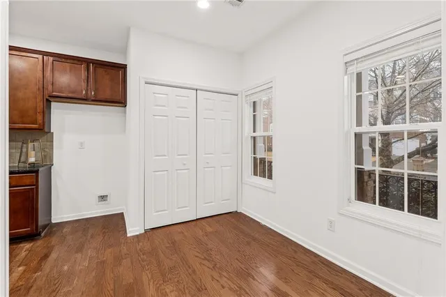 a kitchen with stainless steel appliances granite countertop wooden cabinets a stove a sink and a microwave