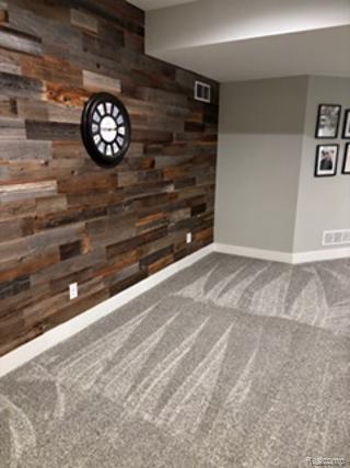 2500 Walnut View Drive Howell, MI 48855 - Photo 25 of 41 Spare room with carpet and wooden walls