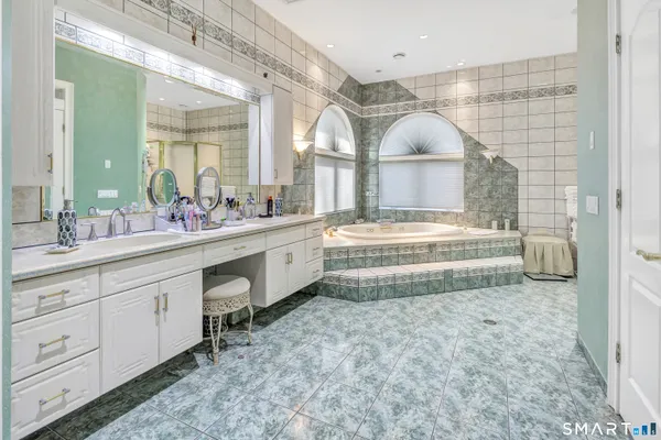 a spacious bathroom with a double vanity sink and a mirror