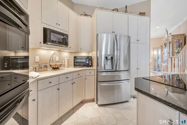 a kitchen with stainless steel appliances a refrigerator sink and microwave