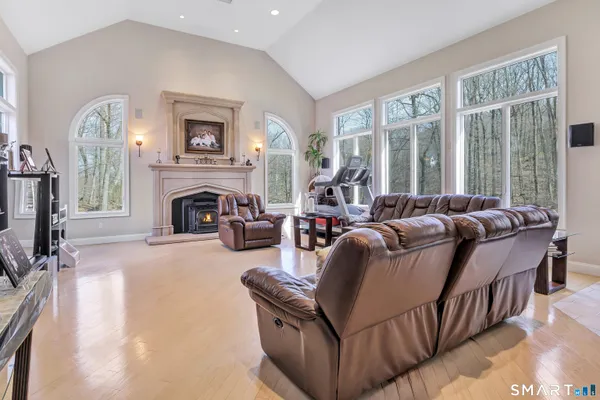 a living room with furniture large window and a fireplace