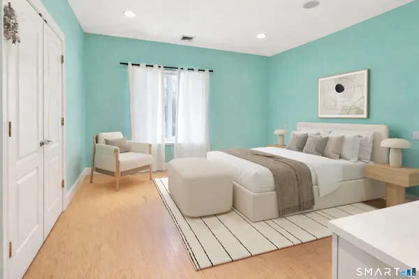 a bedroom with a bed and a couch