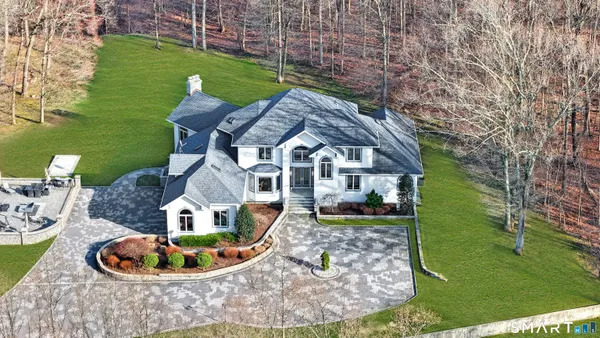 a aerial view of a house with a garden and lake view
