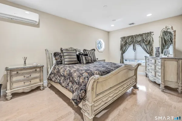 a bedroom with a bed and a night stand
