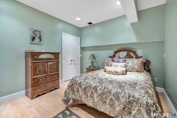 a bedroom with a bed and a dresser