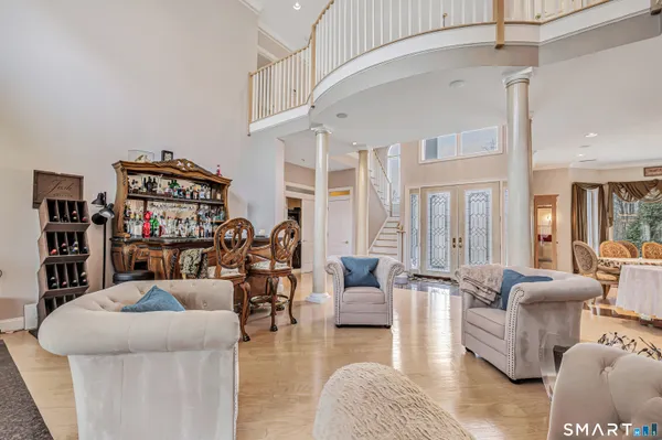 a living room with furniture a rug and a chandelier