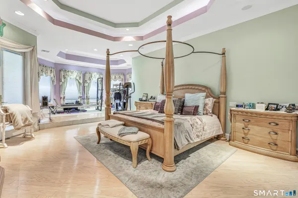 a bedroom with a bed and ceiling fan