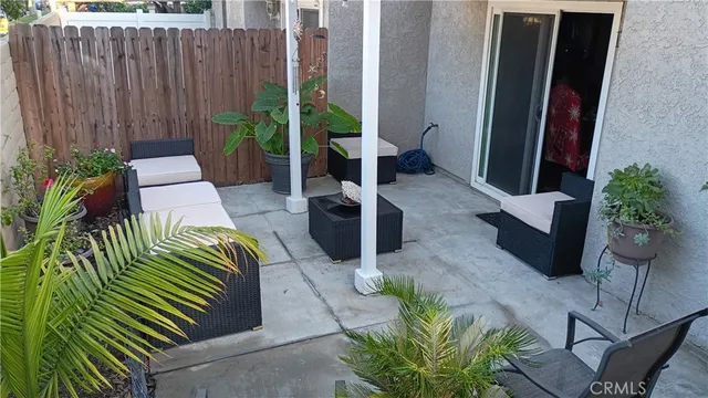 a view of a backyard with plants and a patio