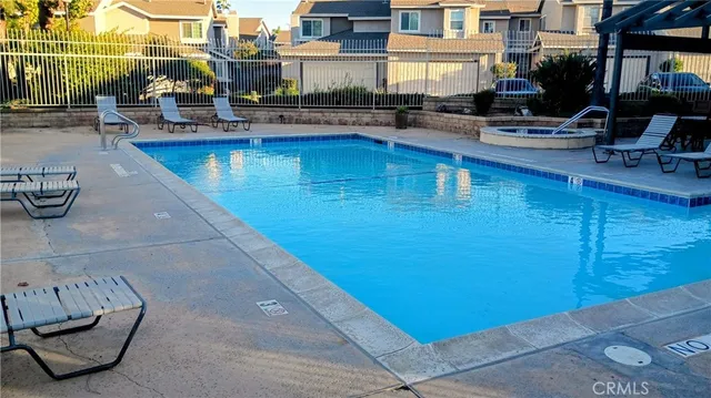 a view of a swimming pool with outdoor seating