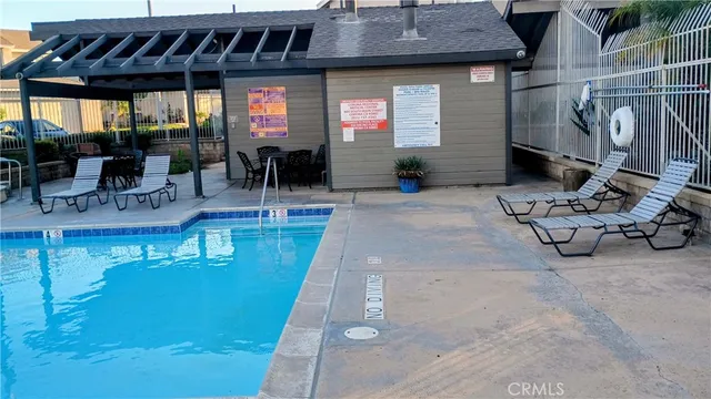 a view of a swimming pool with outdoor seating
