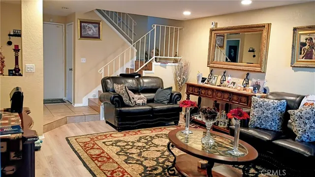 a living room with furniture and a wooden floor
