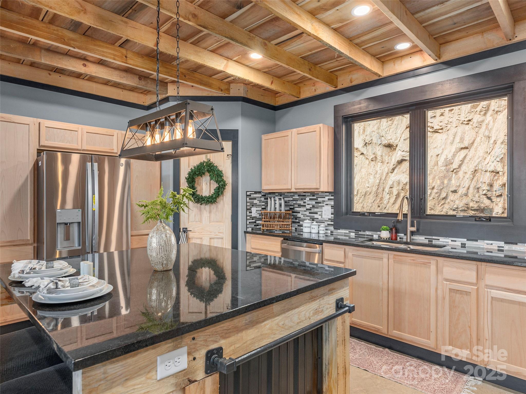 55 Dean Riddle Drive Waynesville, NC 28785 - Photo 12 of 35 a kitchen with stainless steel appliances granite countertop a sink and cabinets