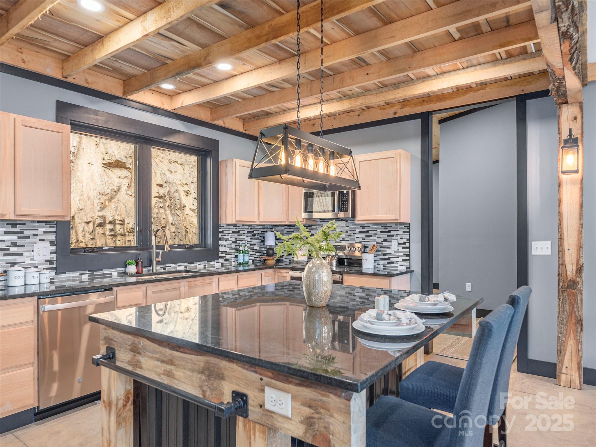 55 Dean Riddle Drive Waynesville, NC 28785 - Photo 13 of 35 a kitchen with a table chairs and window