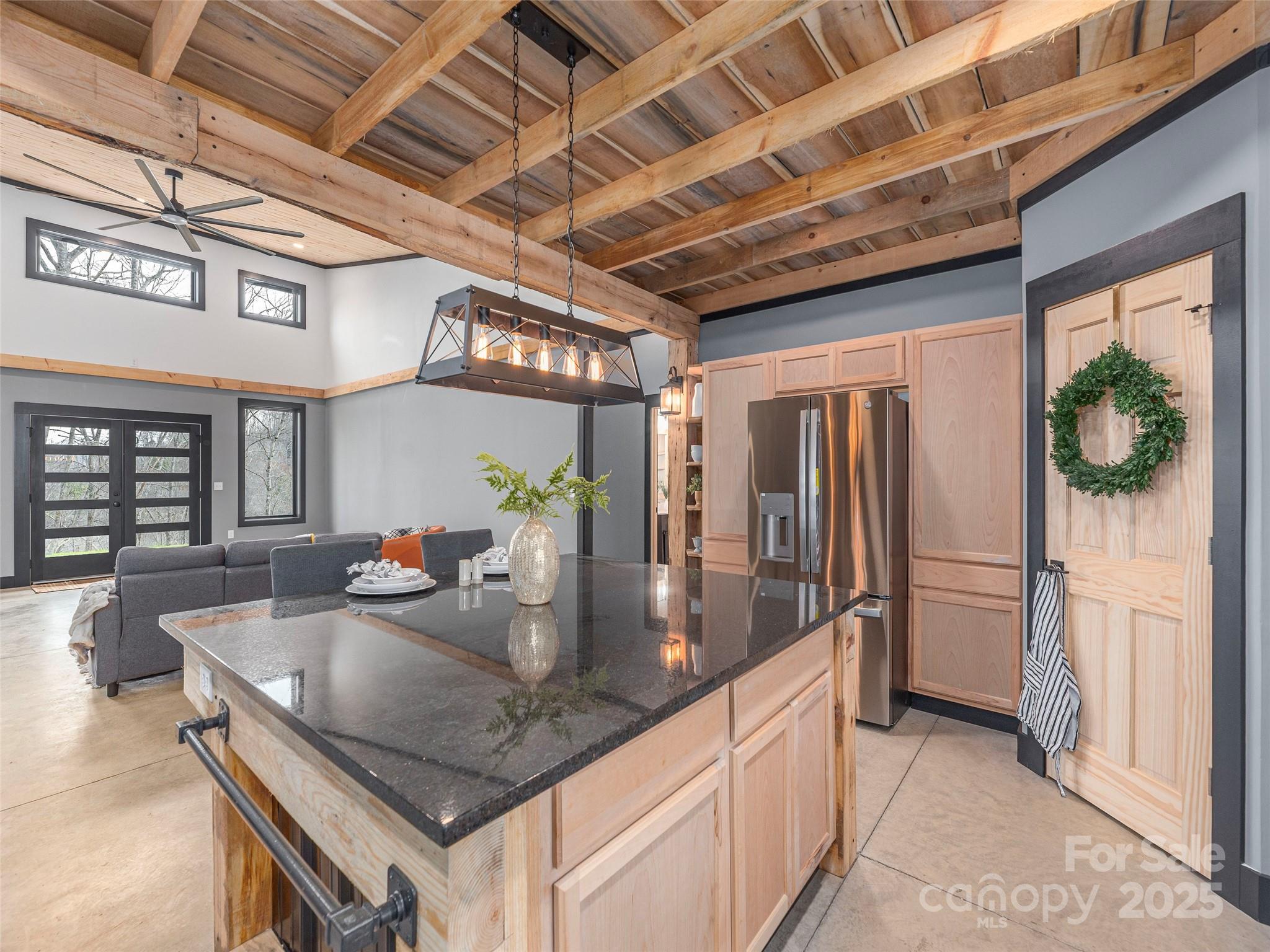 55 Dean Riddle Drive Waynesville, NC 28785 - Photo 15 of 35 a kitchen with stainless steel appliances granite countertop a sink a counter space and a refrigerator