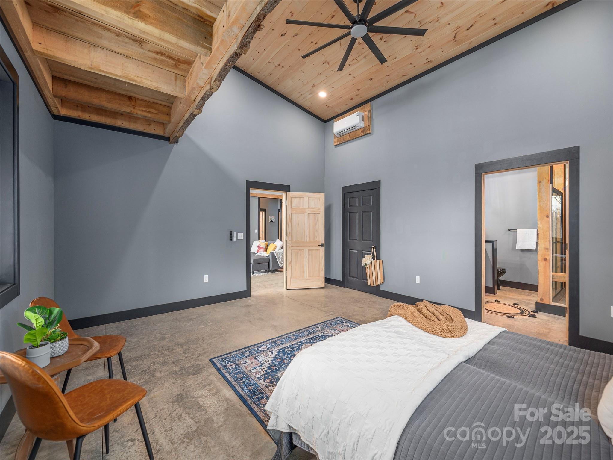 55 Dean Riddle Drive Waynesville, NC 28785 - Photo 18 of 35 a bedroom with a bed and a chandelier