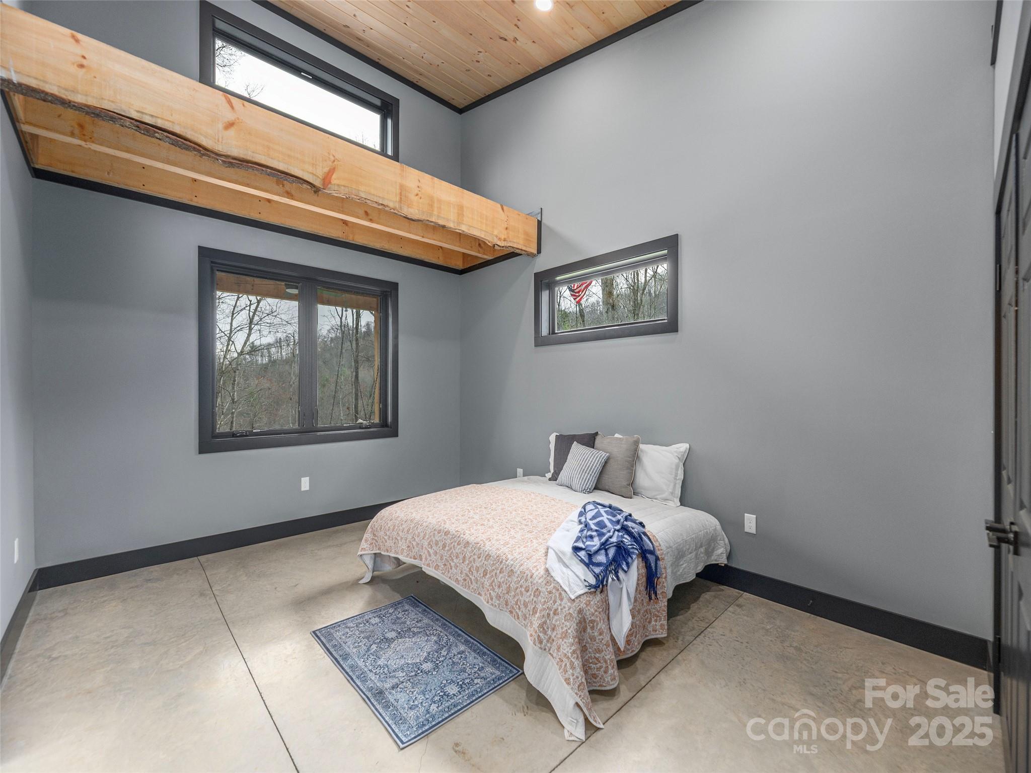 55 Dean Riddle Drive Waynesville, NC 28785 - Photo 23 of 35 a bedroom with a bed and a window